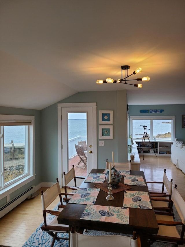 20 Wharf Rd, Blue Hill, ME 04614 - dining area featuring lofted ceiling, a chandelier, a baseboard heating unit, light wood finished floors, and baseboards