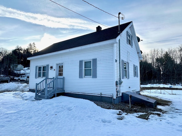 view of front facade with a chimney