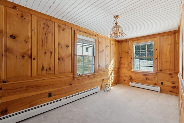 20 Emery Mills Rd, Shapleigh, ME 04076 - spare room with a baseboard radiator, a chandelier, wooden walls, and light carpet