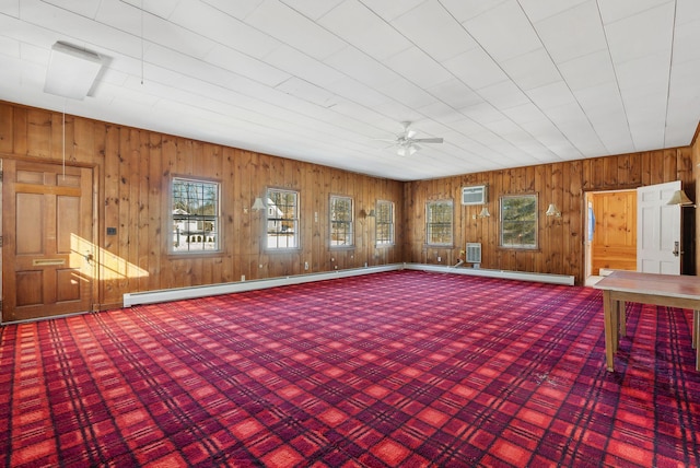 20 Emery Mills Rd, Shapleigh, ME 04076 - unfurnished room featuring an AC wall unit, wooden walls, a ceiling fan, baseboard heating, and carpet flooring