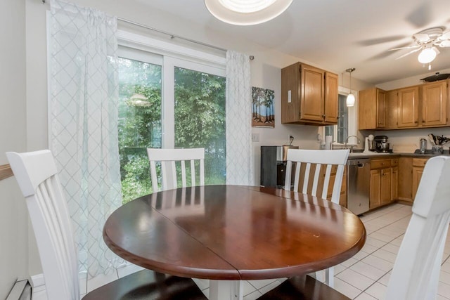 dining room featuring light tile patterned floors, baseboard heating, and a ceiling fan