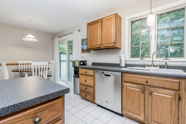 kitchen featuring dark countertops, a sink, hanging light fixtures, and stainless steel dishwasher