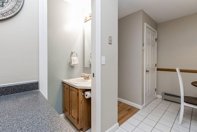 bathroom with tile patterned floors, vanity, and baseboards