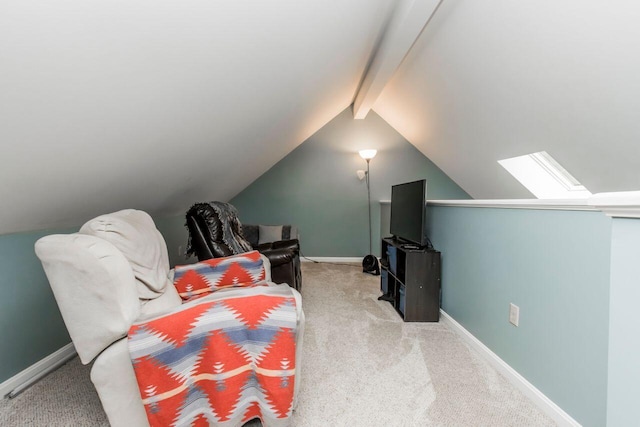 sitting room with lofted ceiling with skylight, carpet, and baseboards