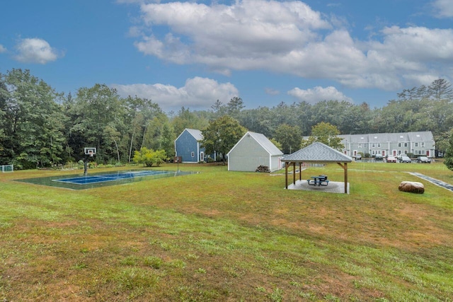 view of yard featuring a gazebo, community basketball court, and a carport