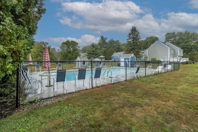 community pool featuring a yard and fence