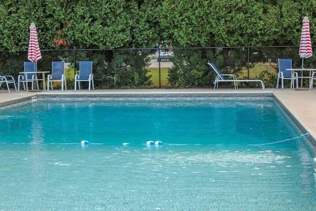 view of swimming pool featuring a patio, fence, and a fenced in pool