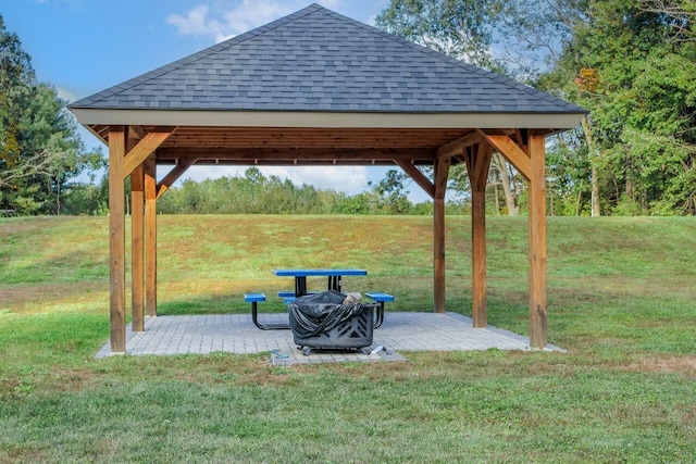 view of community with a gazebo, a lawn, and a patio area