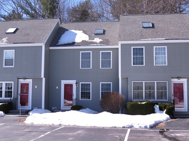 view of property with a shingled roof