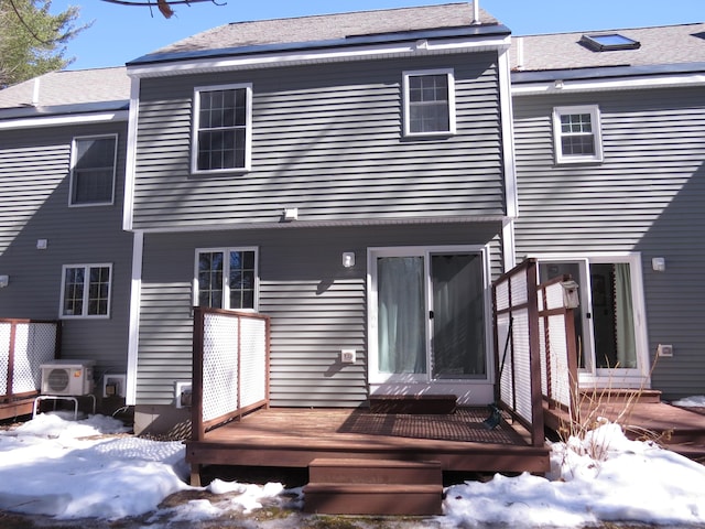 snow covered property featuring a deck and ac unit