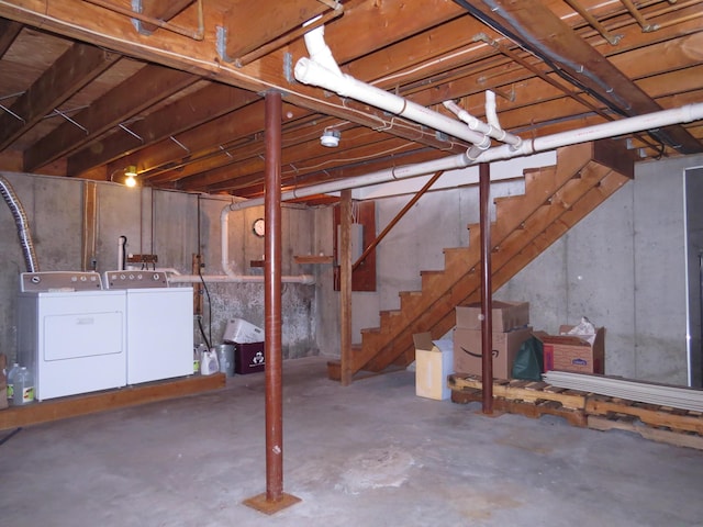 unfinished basement with stairway and washing machine and dryer