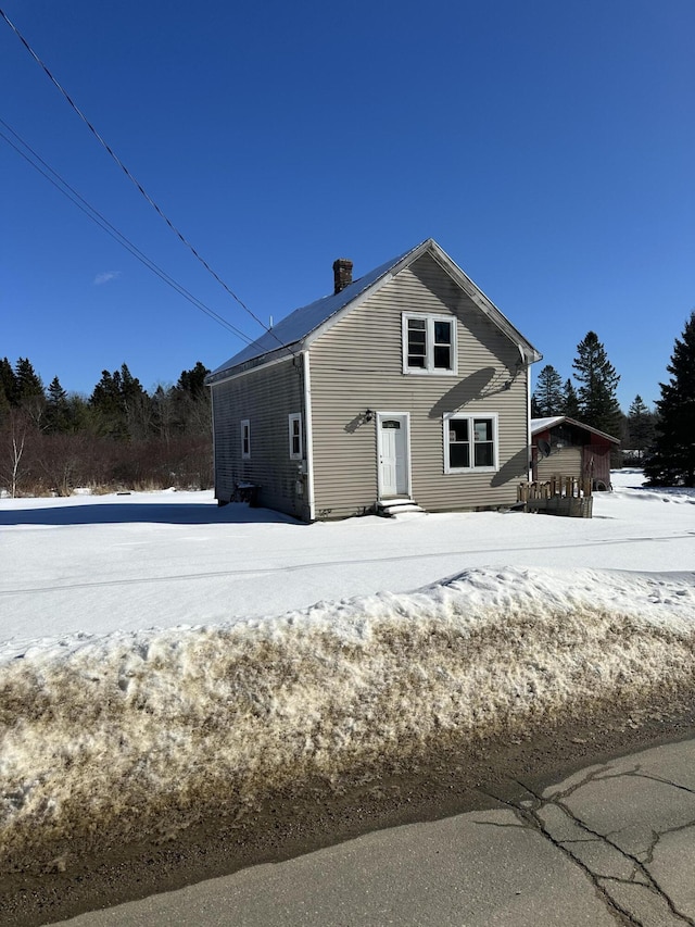 exterior space featuring a chimney