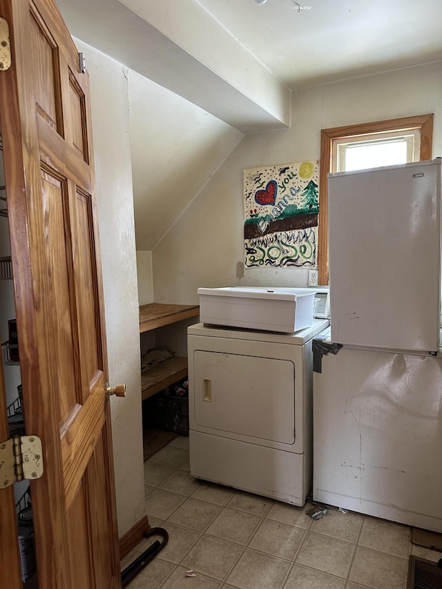 washroom featuring light tile patterned floors, laundry area, and washer / dryer