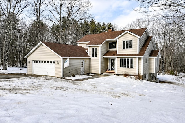 traditional-style home featuring a garage and a chimney