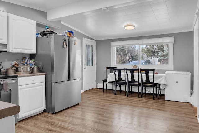 kitchen with a baseboard radiator, white cabinetry, appliances with stainless steel finishes, and light wood finished floors