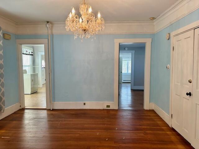 interior space with hardwood / wood-style flooring, baseboards, and ornamental molding