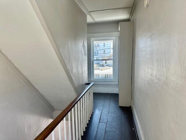 corridor with attic access and dark wood-style flooring