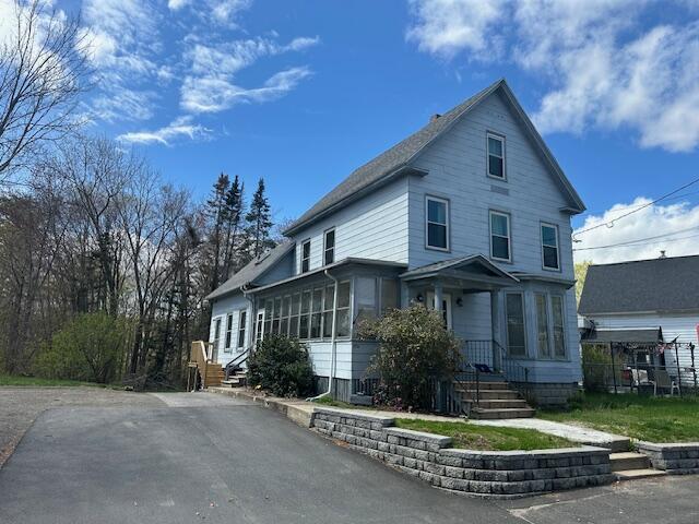 view of front of home featuring a sunroom