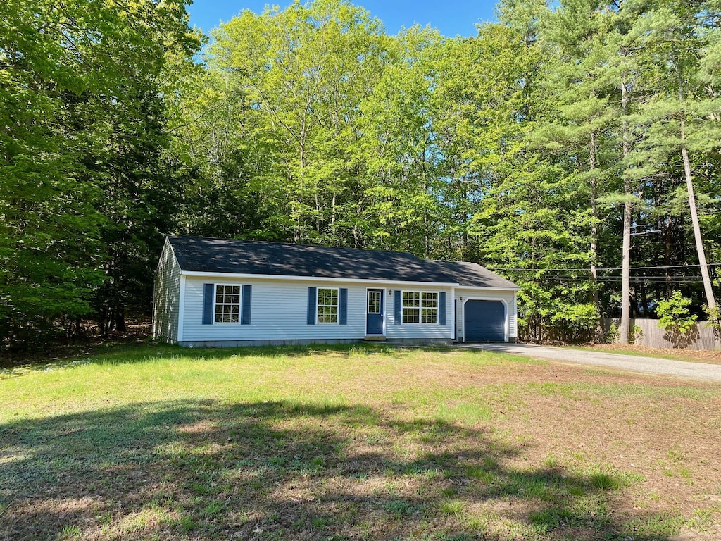 11 Common Way, Buxton, ME 04093 - view of front facade featuring driveway, a garage, and a front lawn