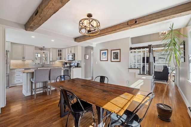 dining area featuring wood finished floors, recessed lighting, beamed ceiling, baseboard heating, and a chandelier