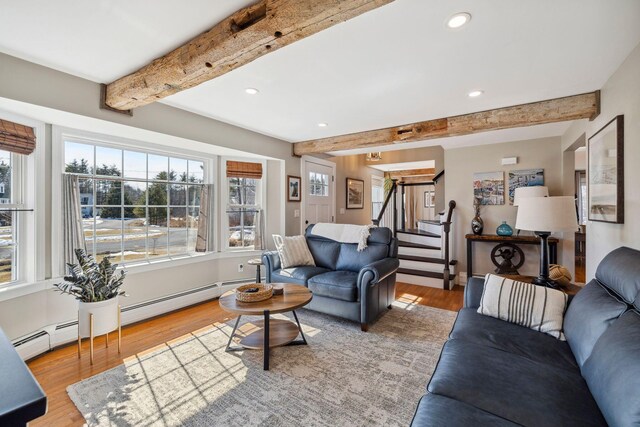 living area with recessed lighting, beamed ceiling, wood finished floors, and stairs