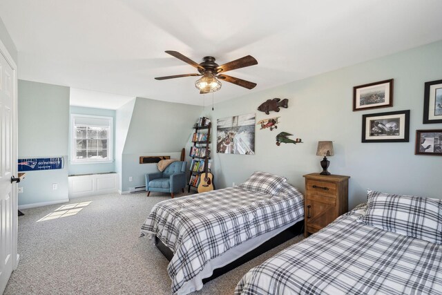 bedroom featuring a ceiling fan, carpet, baseboards, and baseboard heating