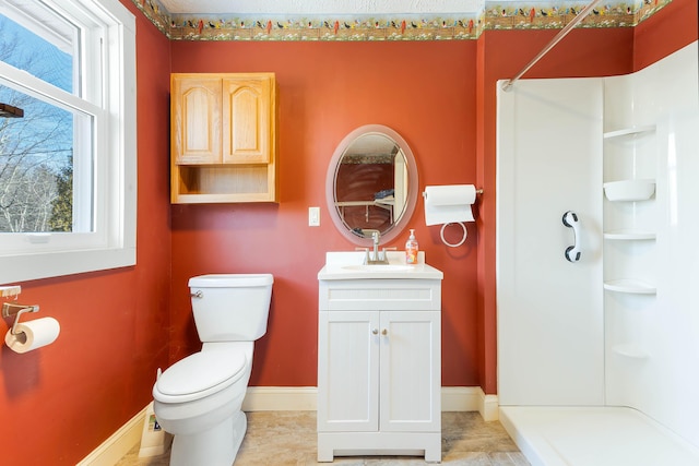 full bath featuring baseboards, toilet, walk in shower, and vanity