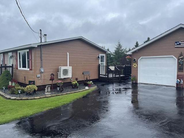 view of home's exterior with ac unit, aphalt driveway, a lawn, and a wooden deck