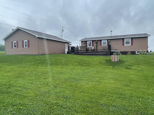 back of property with a yard and a deck