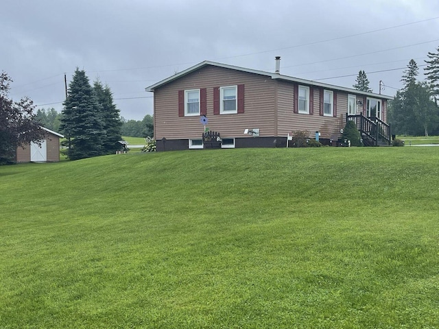 view of side of property with a lawn