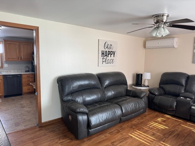 living area with baseboards, an AC wall unit, ceiling fan, and wood finished floors