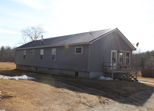 view of side of property featuring metal roof