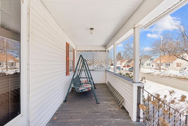 deck featuring a porch and a residential view