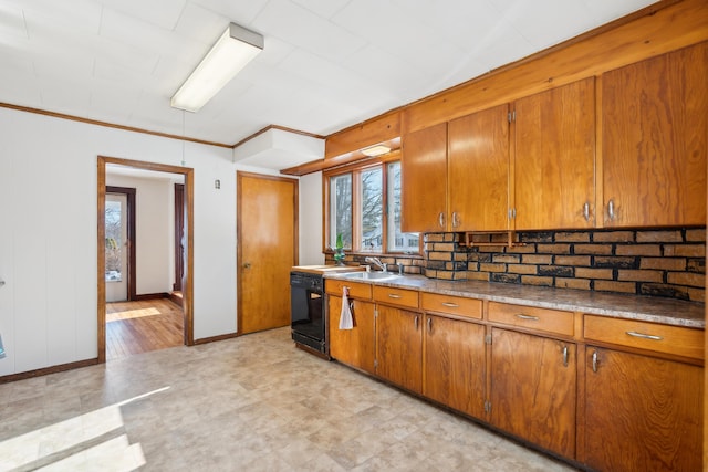 kitchen with black dishwasher, brown cabinetry, backsplash, and a sink