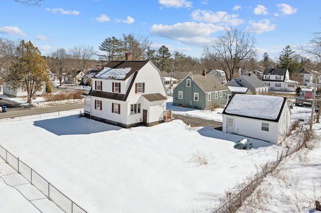 snowy aerial view with a residential view