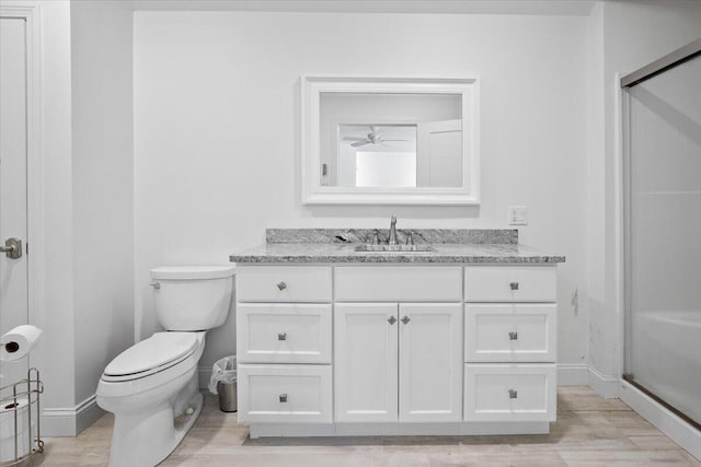 full bathroom with vanity, toilet, wood finished floors, and a shower with shower door