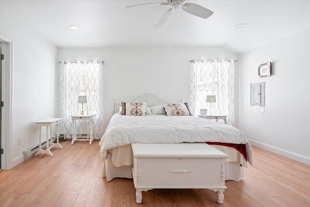 bedroom featuring light wood-type flooring, lofted ceiling, electric panel, baseboards, and baseboard heating