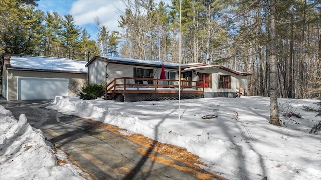 view of front of house with a deck and a garage