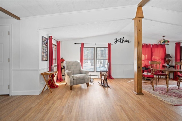 living area featuring lofted ceiling and wood finished floors