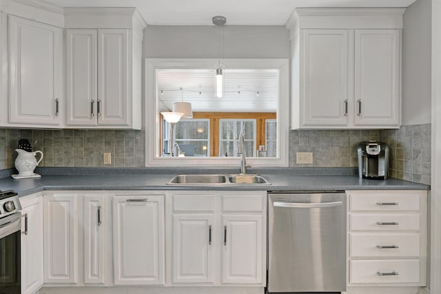 kitchen featuring a sink, stainless steel appliances, white cabinetry, dark countertops, and tasteful backsplash