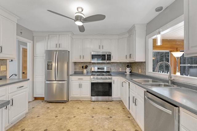 kitchen featuring a sink, appliances with stainless steel finishes, white cabinets, and a ceiling fan