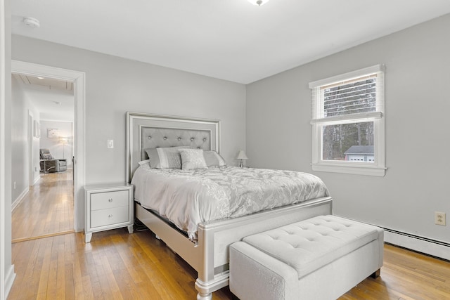 bedroom with attic access and hardwood / wood-style flooring