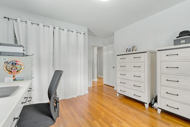 office area with light wood-style flooring and baseboards