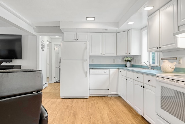 kitchen featuring light wood-style flooring, white appliances, white cabinets, and a sink