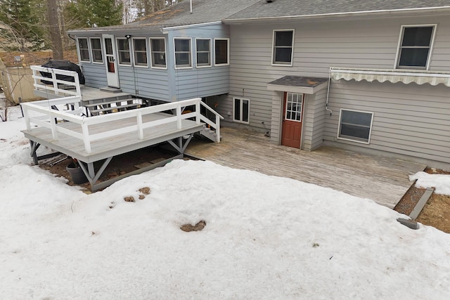 back of house featuring a deck, a sunroom, and roof with shingles