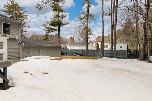 snowy yard with fence