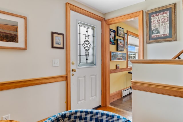 entryway featuring wood finished floors and baseboard heating