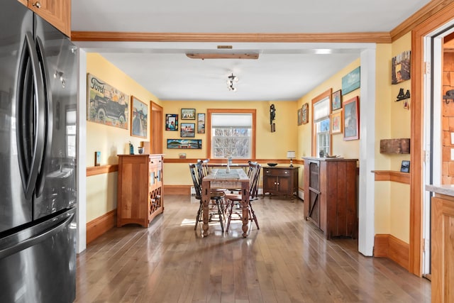 dining area with baseboards and hardwood / wood-style flooring