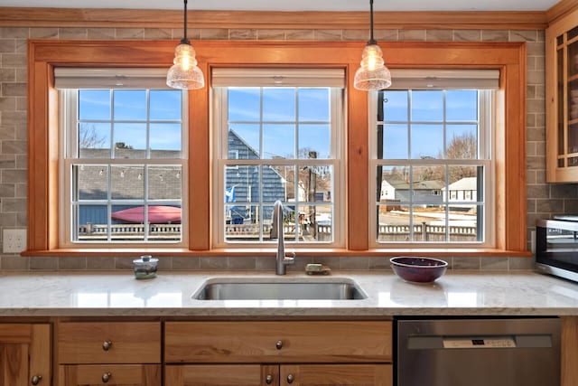 kitchen featuring tasteful backsplash, a healthy amount of sunlight, stainless steel appliances, and a sink