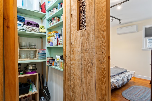 storage area with a wall mounted air conditioner